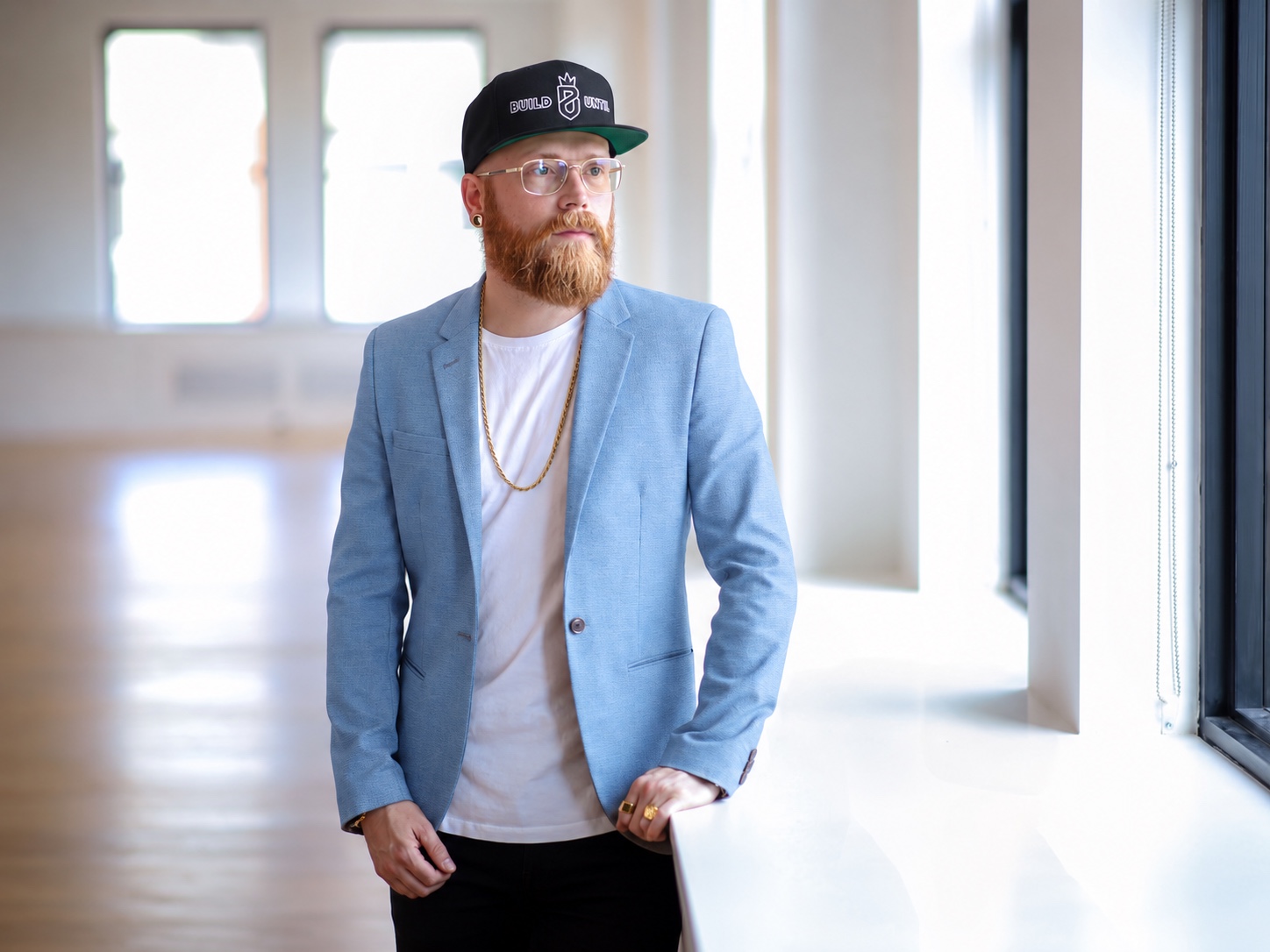 Jesse Wood in a Build Until hat, looking toward the right of the frame