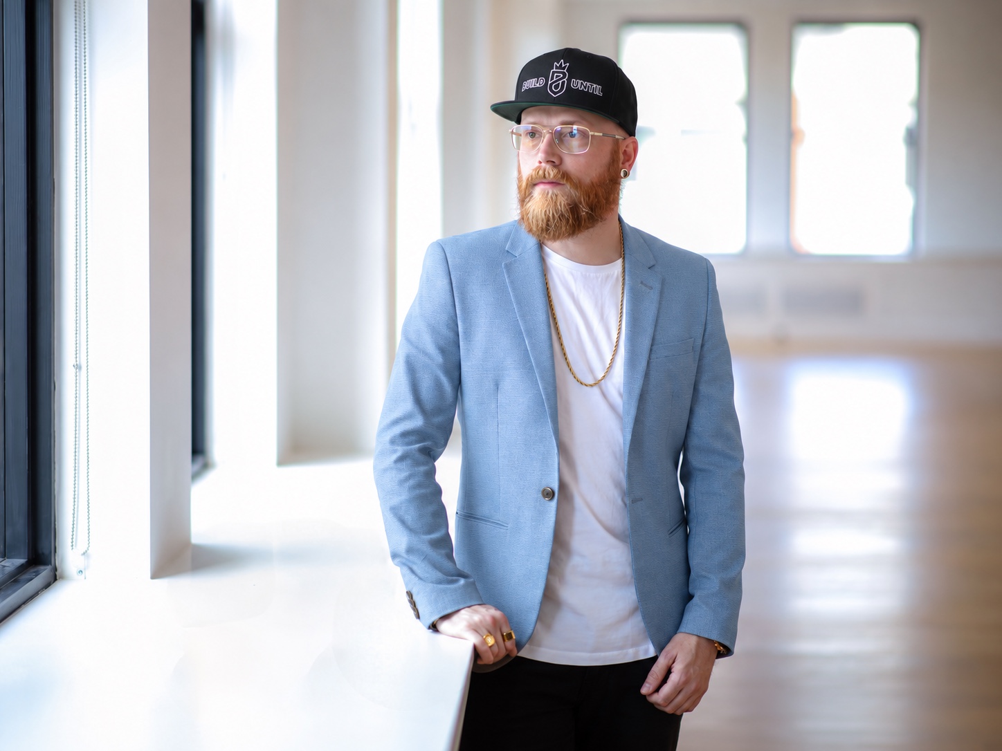 Jesse Wood in a Build Until hat, looking toward the left of the frame
